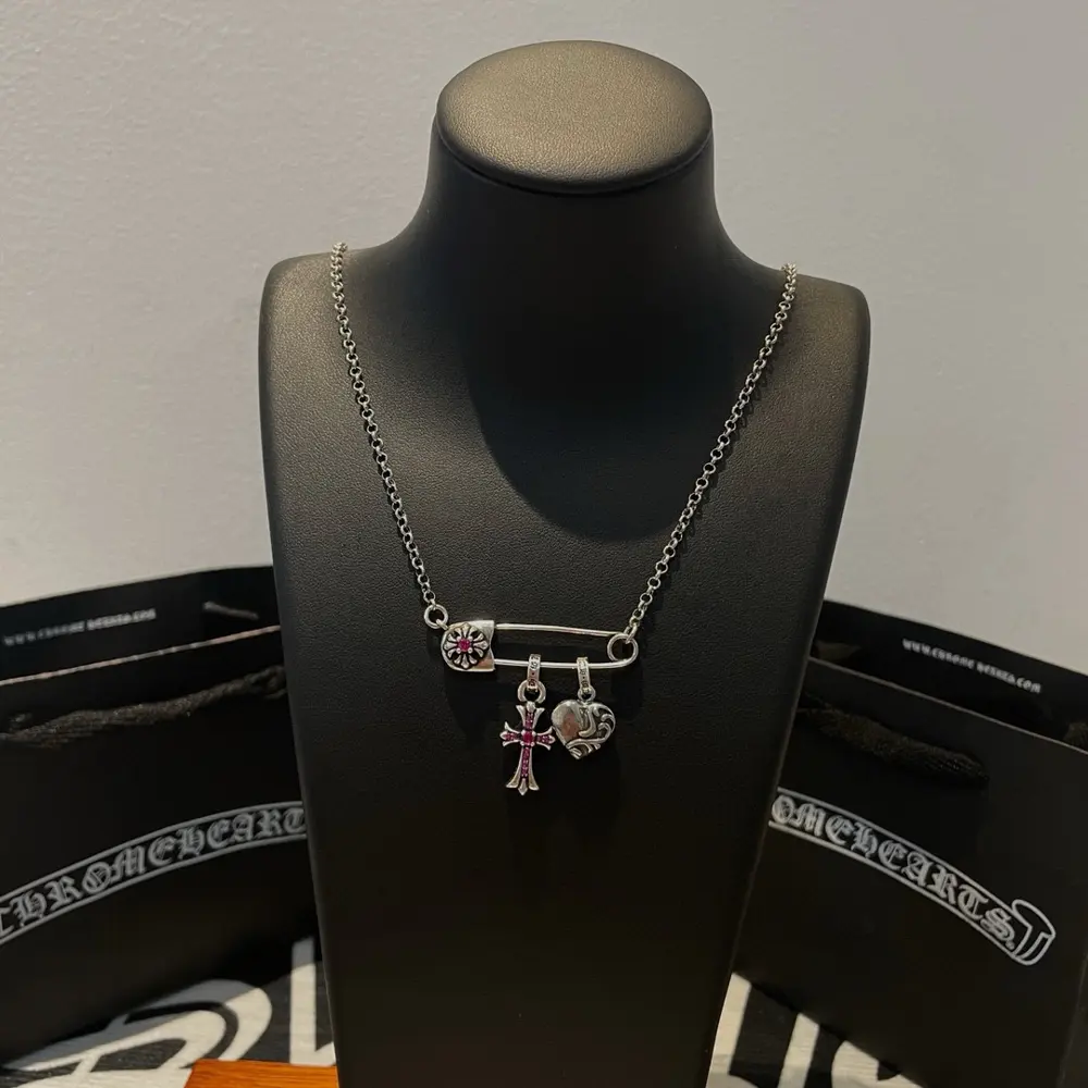Chrome Hearts classic ten-paper clip cross love necklace. The concave and convex shapes