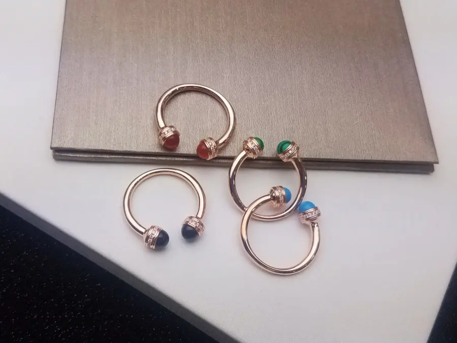 PIAGET has two cabochons of black agate/carnelian/malachite/turquoise and a diamond-paved