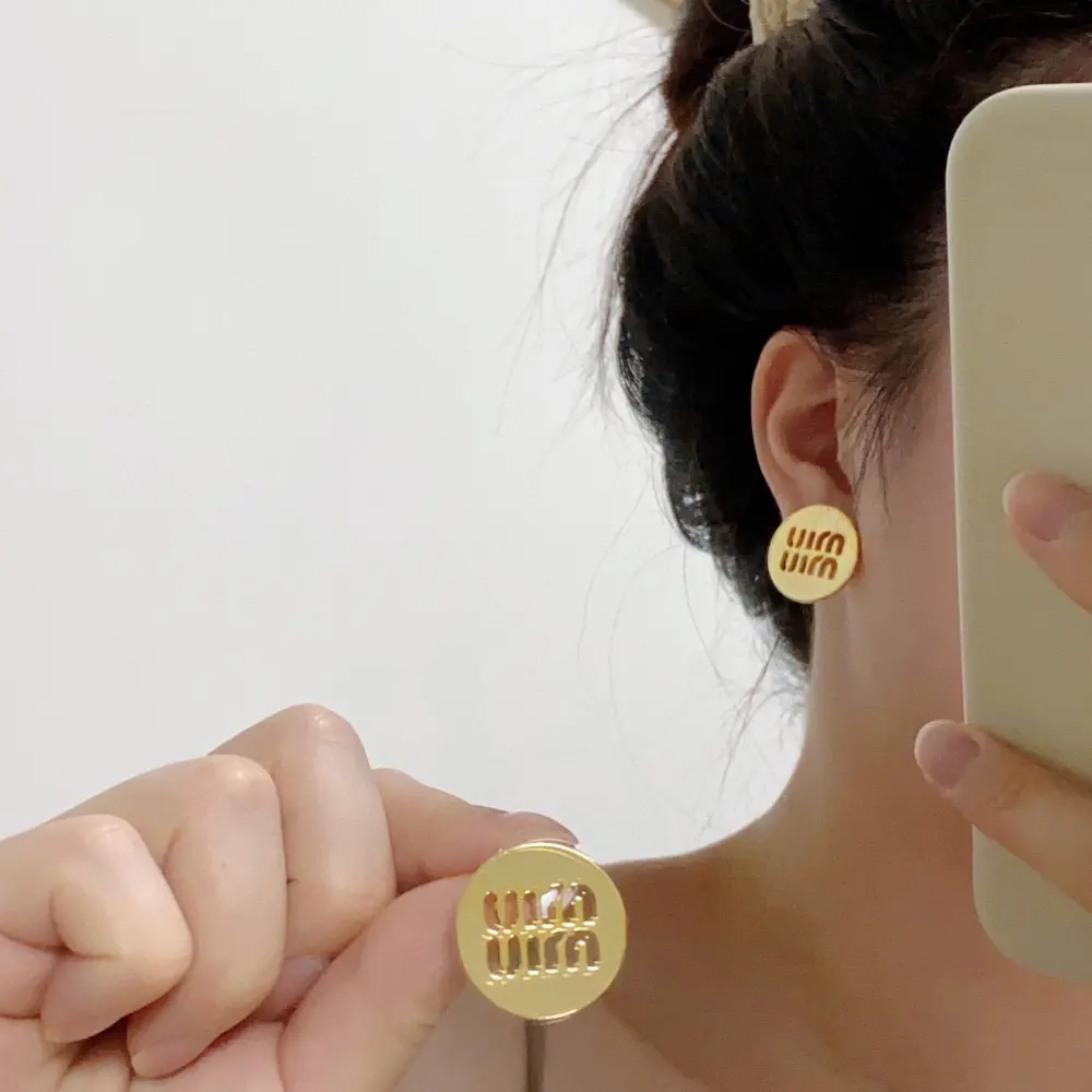 miumiu round hollow letter design earrings