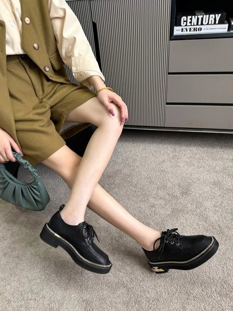 Chanel leather shoes with gold hardware buckle and chain