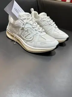 Valentino low-top sneakers are crafted from imported mesh fabrics and enhanced with zigzag