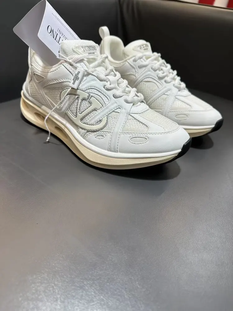 Valentino low-top sneakers are crafted from imported mesh fabrics and enhanced with zigzag