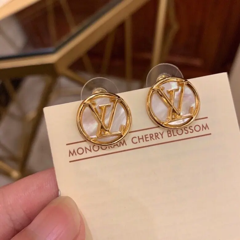 Louis Vuitton white shell earrings with lettering