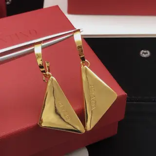 [Prada’s latest triangular ear hook]