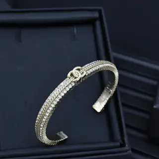 Chanel gold embossed braided rhinestone double c open bracelet