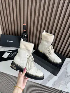 Chanel ankle boots with gold hardware buckle and chain