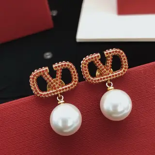 Valentino V-shaped earrings with diamonds and red pearls
