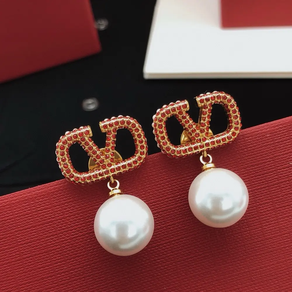Valentino V-shaped earrings with diamonds and red pearls