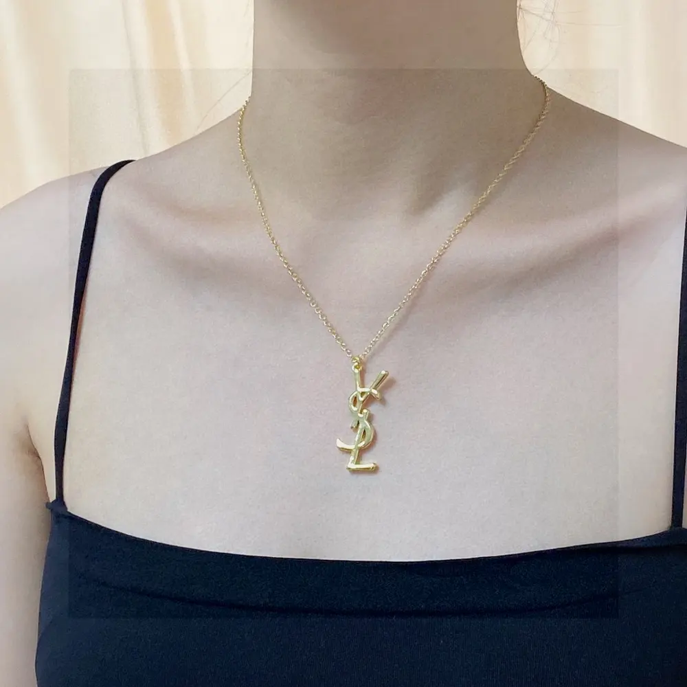 Yves Saint Laurent letter pendant antique gold necklace