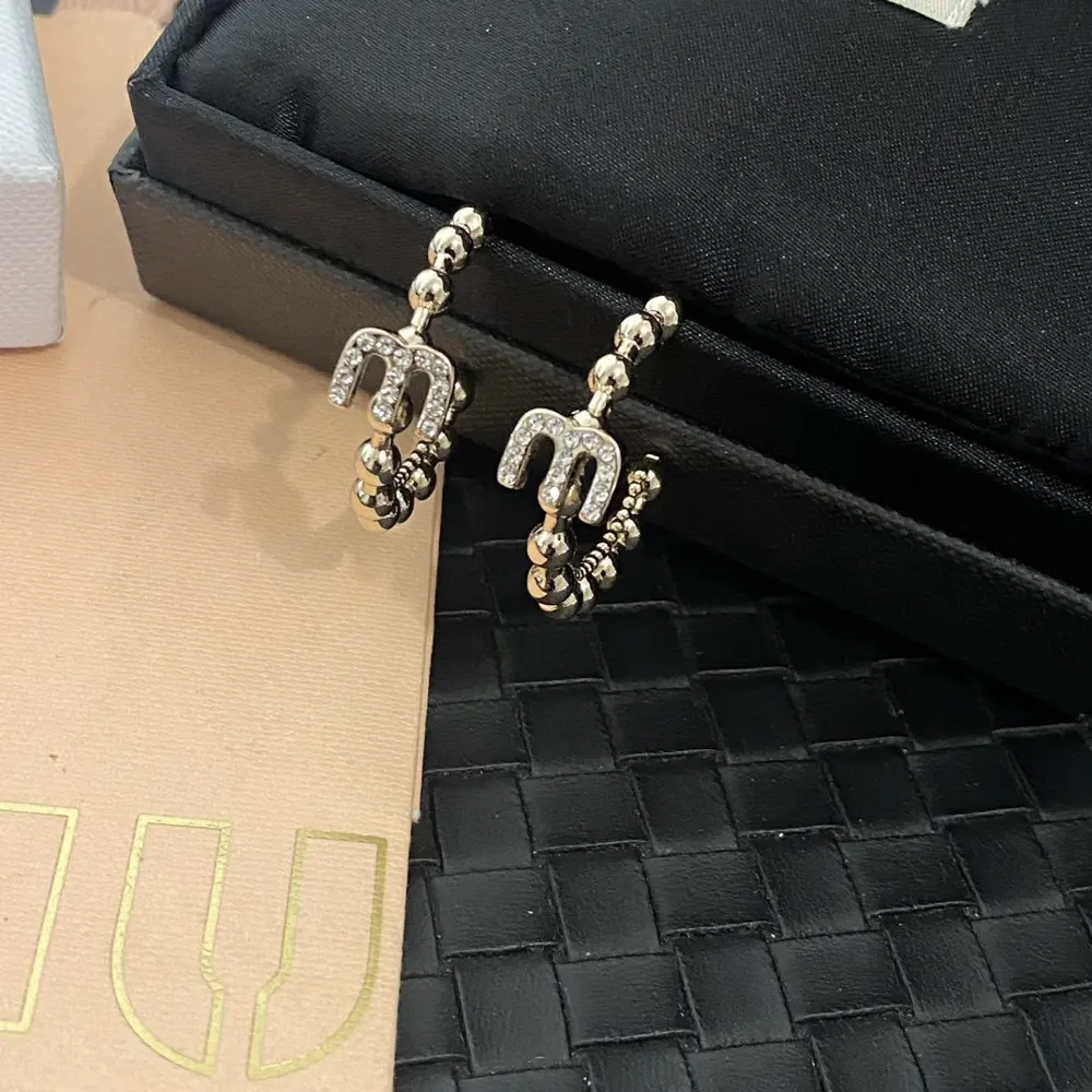miumiu round crystal diamond letter earrings