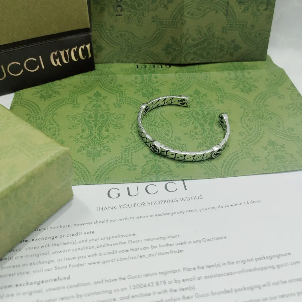 GUcci’s bracelet features a 5G interlocking double G monogram pattern and a horse-curtain