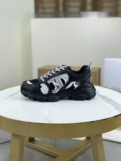 Dior CHRONO shoes have a lot of silver shiny structures with gray mesh materials. The soles