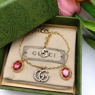 Gucci Double G Bracelet The highly recognizable Double G logo with a large gem Different