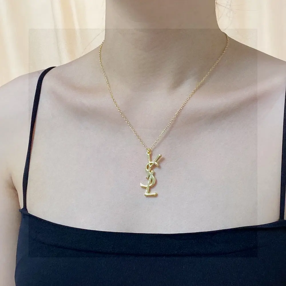 Yves Saint Laurent letter pendant antique gold necklace