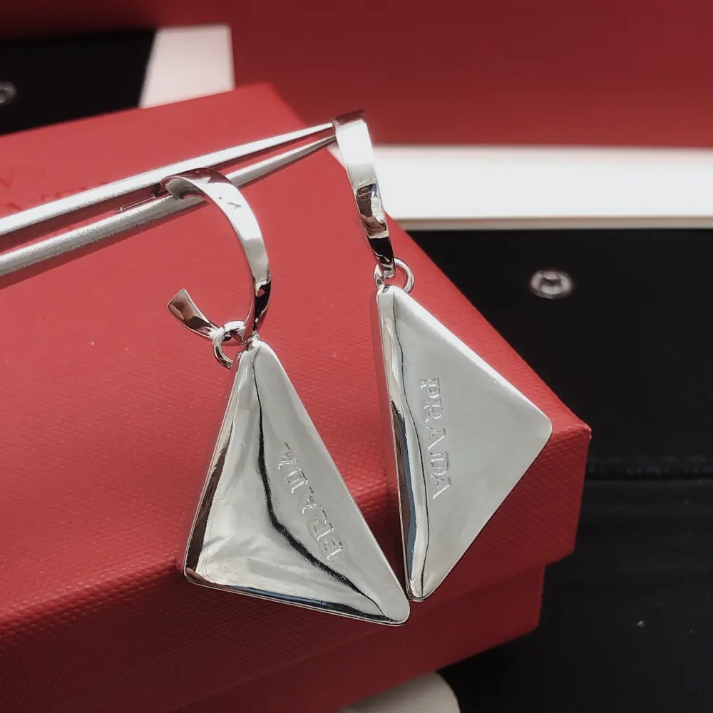 [Prada’s latest triangular ear hook]