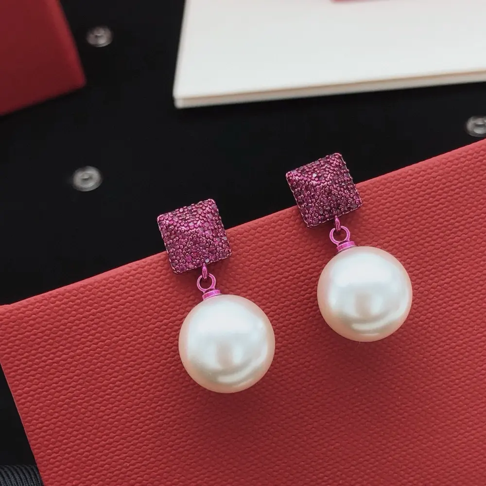 Valentino earrings with squares and triangles forming a purple diamond-studded pearl