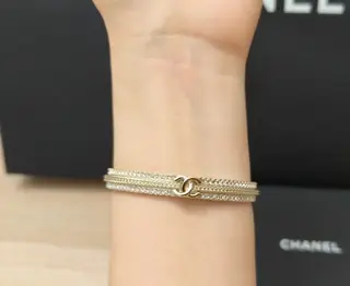 Chanel gold embossed braided rhinestone double c open bracelet
