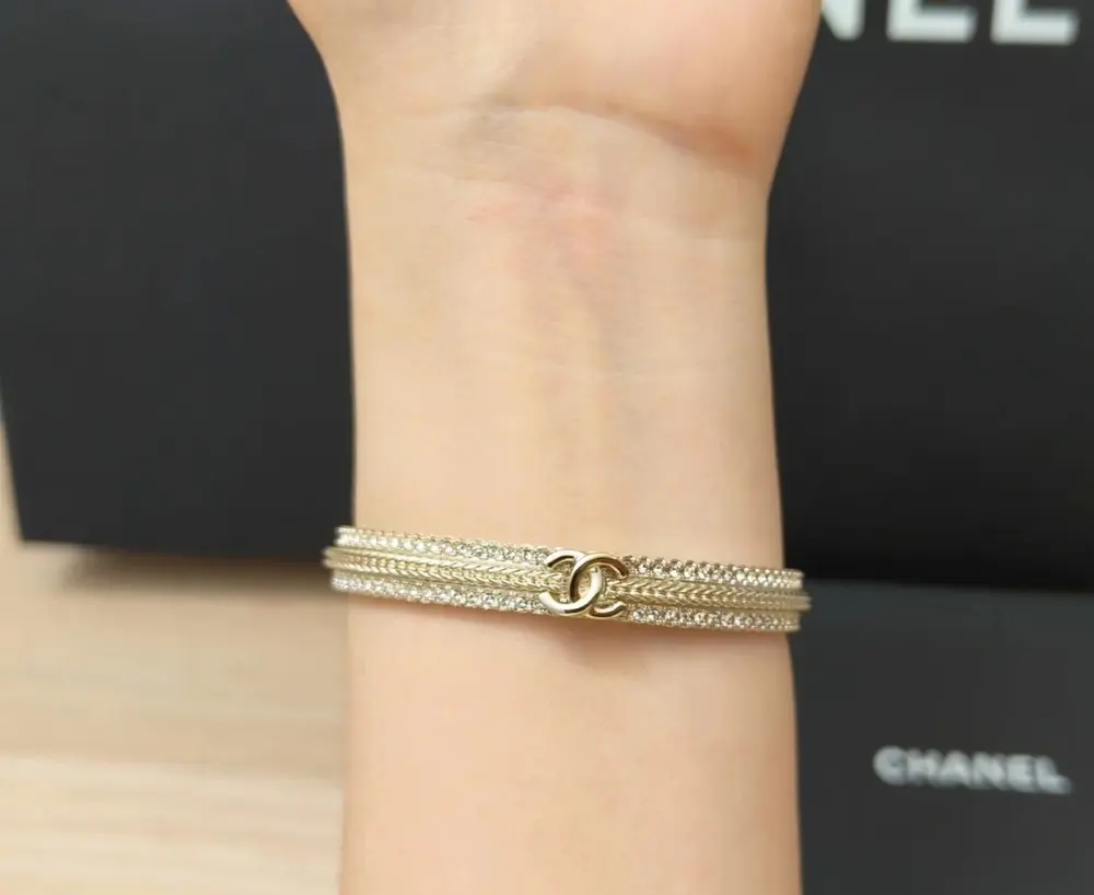 Chanel gold embossed braided rhinestone double c open bracelet