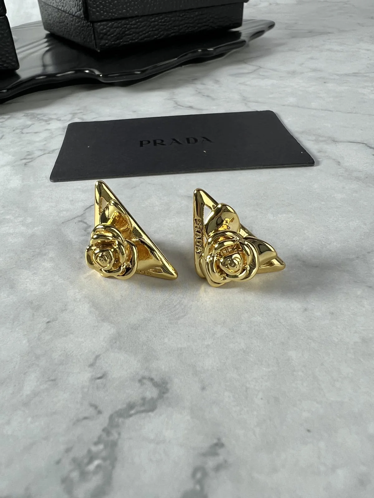 Prada flower triangle earrings