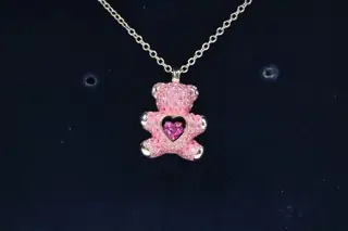 Swarovski stylish asymmetrical design. One earring is a 3D teddy bear head with a Swarovski