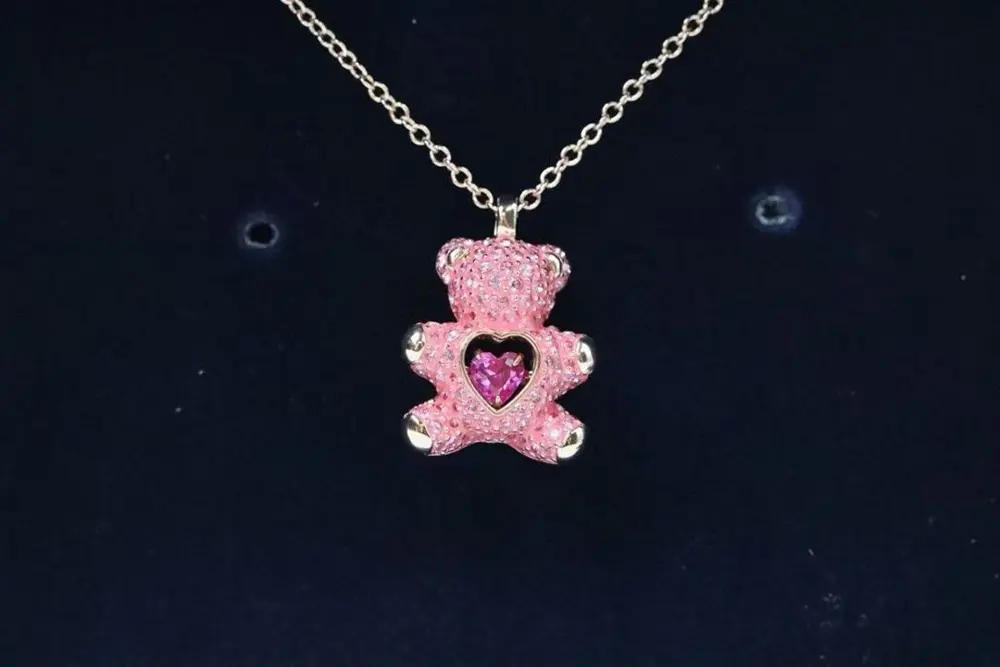 Swarovski stylish asymmetrical design. One earring is a 3D teddy bear head with a Swarovski