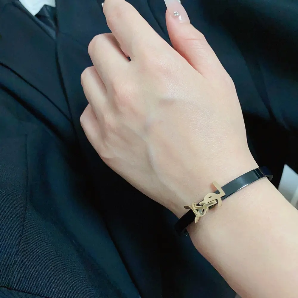 Yves Saint Laurent engraved lettering narrow rose gold and charcoal black bracelet