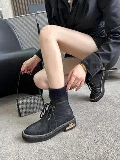 Chanel ankle boots with gold hardware buckle and chain