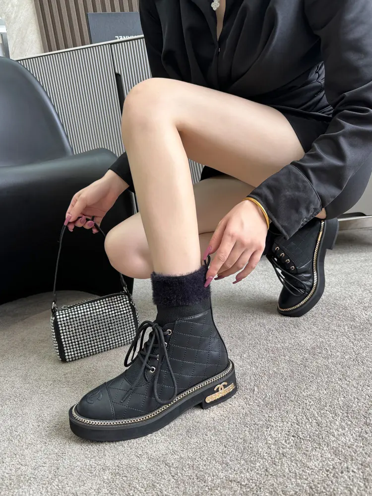 Chanel ankle boots with gold hardware buckle and chain