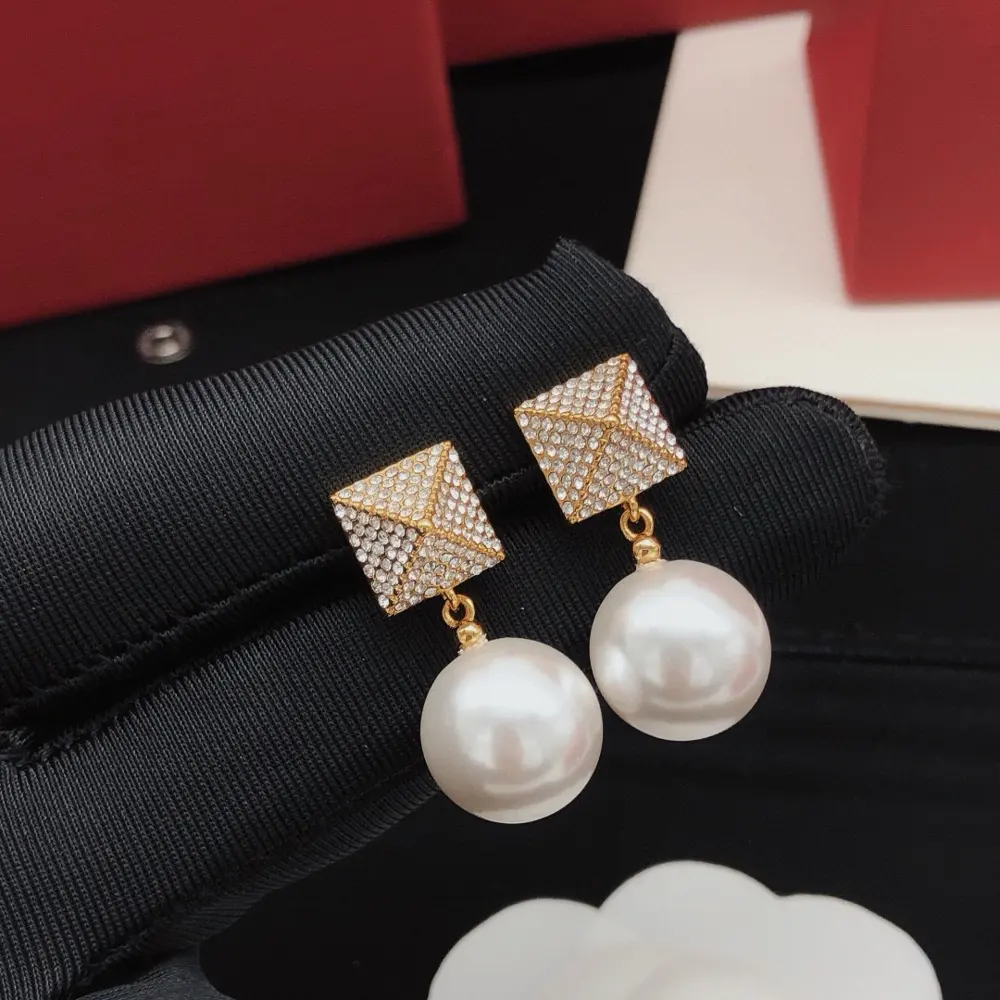 Valentino earrings with squares and triangles inlaid with diamonds and pearls